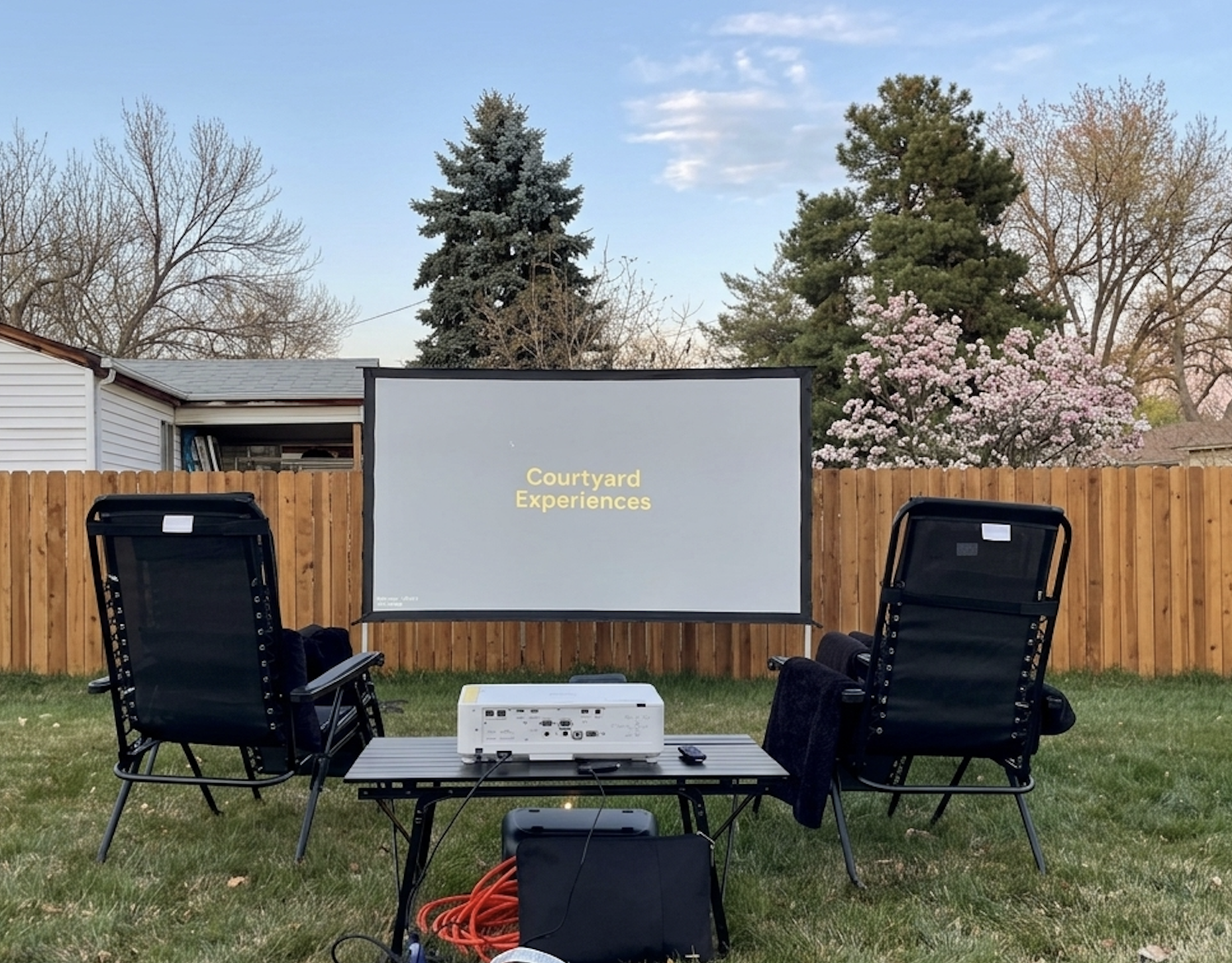 Spring backyard outdoor movie night in Denver with screen and seating