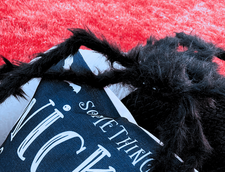 Cozy outdoor Halloween movie night setup with blankets and lanterns